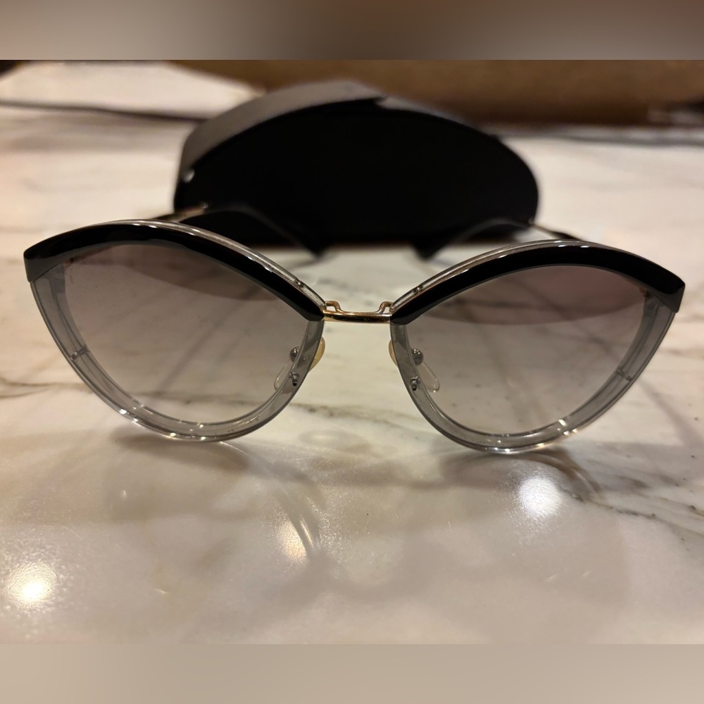 Prada SPR 07U in color code U43-5O0 is a pair of women's "Catwalk" sunglasses.